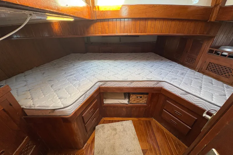 Slide: The Image of Cozy wooden cabin interior with a custom mattress on a 1979 Formosa 51 sailboat. - 34