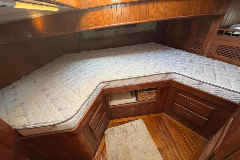 Slide: The Image of Cozy wooden cabin interior with a custom mattress on a 1979 Formosa 51 sailboat. - 35