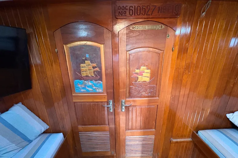 Slide: The Image of Wooden interior of 1979 Formosa 51 yacht with carved ship doors and cozy seating. - 36