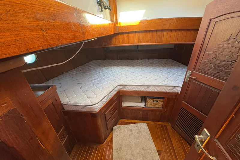 Slide: The Image of Cozy cabin interior of 1979 Formosa 51 sailboat with wooden finish and mattress. - 38