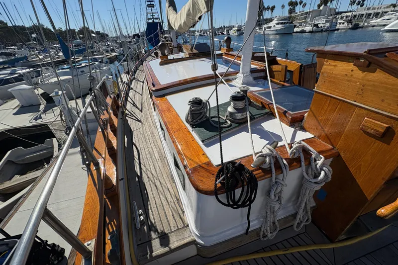Slide: The Image of 1979 Formosa 51 sailboat deck with ropes and winches in a marina setting. - 6