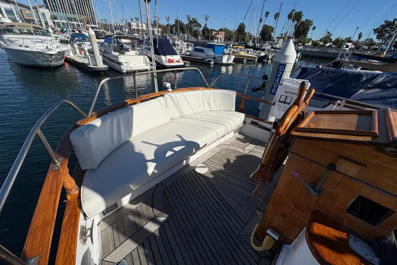 Slide: The Image of Cockpit of a 1979 Formosa 51 yacht with white seating, docked at a marina. - 7
