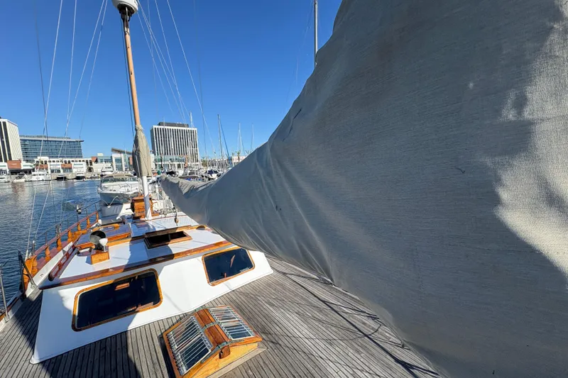 Slide: The Image of Sailboat docked in marina, Formosa 51, 1979 model, with covered sail and wooden deck. - 8