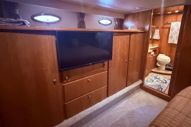 Slide: The Image of Luxurious 2007 Navigator 58 yacht interior with TV, wooden cabinets, and bathroom. - 10
