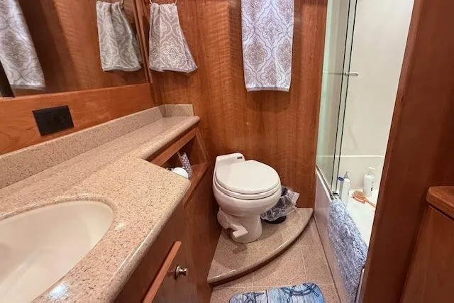 Slide: The Image of Luxurious bathroom in 2007 Navigator 58 yacht with elegant wood finish and modern amenities. - 11