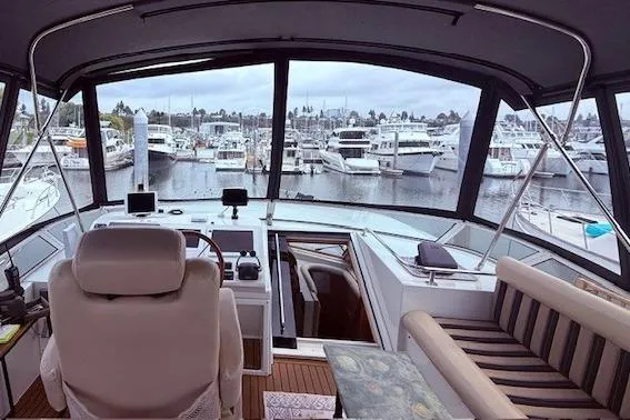 Slide: The Image of Interior view of 2007 Navigator 58 yacht cockpit overlooking marina with multiple boats. - 14