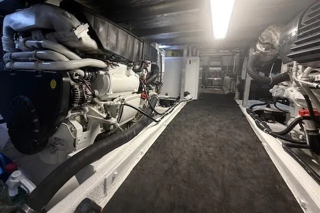 Slide: The Image of Engine room of a 2007 Navigator 58 yacht, featuring well-maintained machinery and equipment. - 26