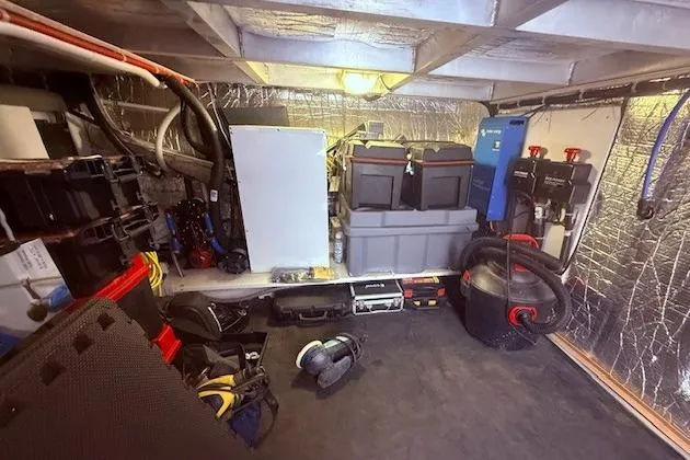 Slide: The Image of Engine room of a 2007 Navigator 58 yacht with equipment and storage. - 27