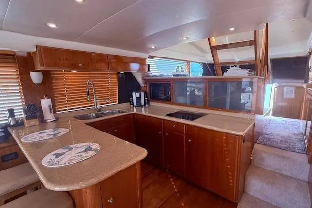 Slide: The Image of Luxurious 2007 Navigator 58 yacht interior with modern kitchen and elegant wood finishes. - 4