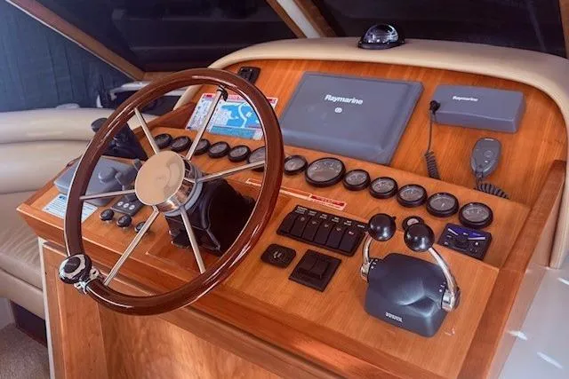 Slide: The Image of 2007 Navigator 58 yacht helm with wooden steering wheel and navigation controls. - 6