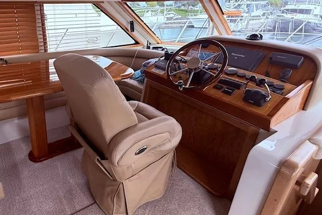 Slide: The Image of Luxurious 2007 Navigator 58 yacht interior with helm, leather seating, and wooden accents. - 7