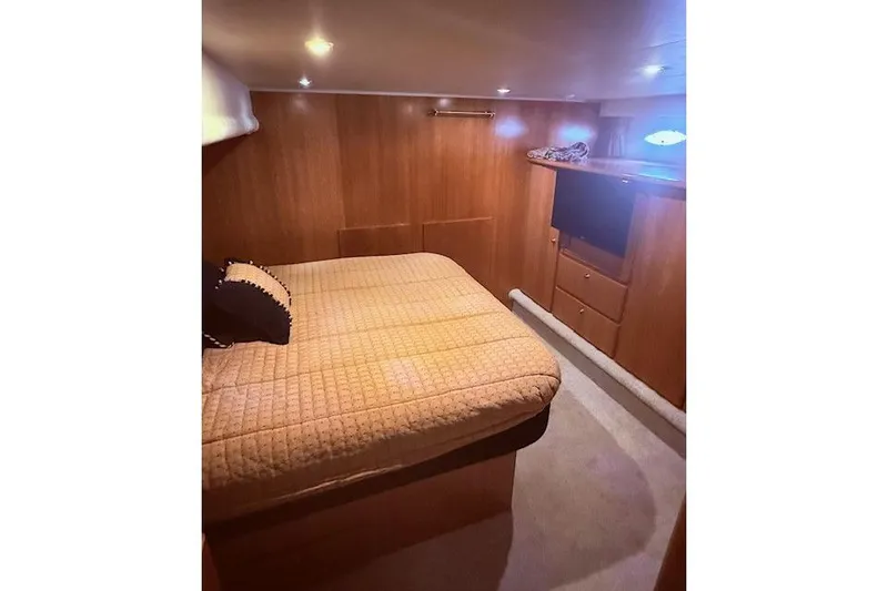 Slide: The Image of Luxurious bedroom interior of 2007 Navigator 58 yacht with cozy bed and wooden cabinetry. - 9