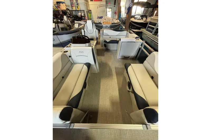 Slide: The Image of 2025 Avalon Venture Cruise Rear Bench boat interior with plush seating in showroom. - 17