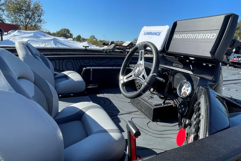 Slide: The Image of 2024 Xpress X21 Pro boat interior with steering wheel, seats, and navigation systems. - 6