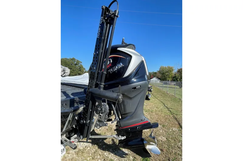 Slide: The Image of 2024 Xpress X21 Pro boat engine with sleek design, parked outdoors under clear blue sky. - 7