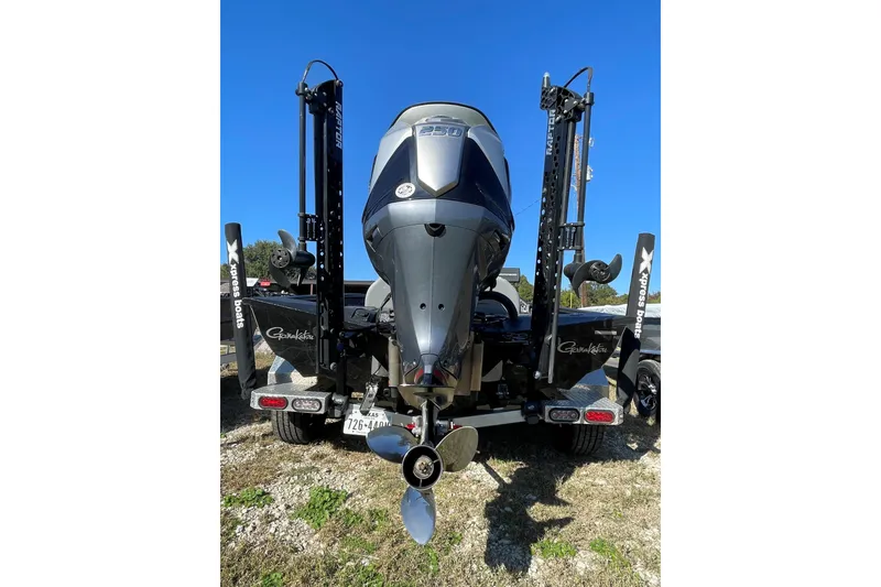 Slide: The Image of 2024 Xpress X21 Pro boat rear view with powerful outboard motor and dual power poles. - 8