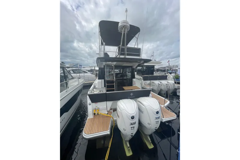 The Image of 2026 Jeanneau NC 1095 Fly Series 2 boat with twin Yamaha 300 engines at marina. - 0