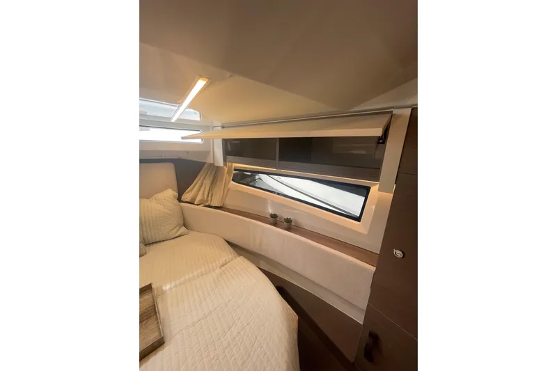 Slide: The Image of 2026 Jeanneau NC 1095 Fly Series 2 cabin interior with modern design and cozy bedding. - 14