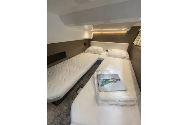 Slide: The Image of Interior cabin of 2026 Jeanneau NC 1095 Fly Series 2 with twin beds and magazine. - 15
