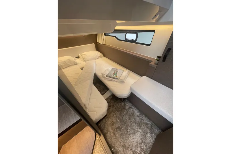 Slide: The Image of Interior cabin of 2026 Jeanneau NC 1095 Fly Series 2, featuring cozy bedding and modern design. - 16
