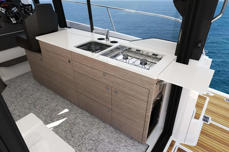 Slide: The Image of 2026 Jeanneau NC 1095 Fly Series 2 yacht interior with modern kitchen and ocean view. - 21