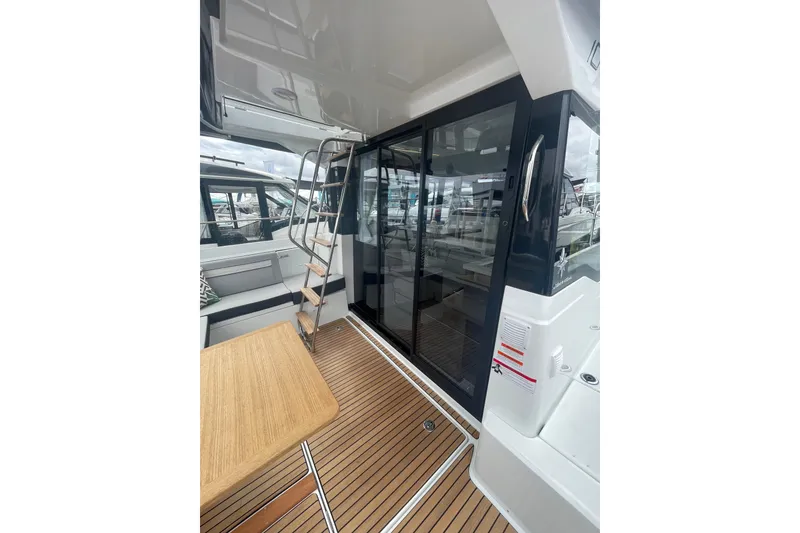 Slide: The Image of 2026 Jeanneau NC 1095 Fly Series 2 yacht deck with seating and ladder. - 3