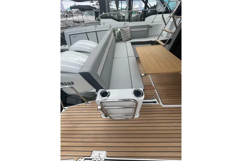 Slide: The Image of 2026 Jeanneau NC 1095 Fly Series 2 boat deck with seating and table. - 4
