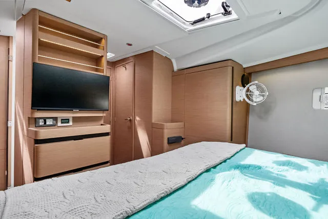 Slide: The Image of Interior cabin of 2026 Jeanneau NC 1095 Fly Series 2 with bed and ambient lighting. - 44