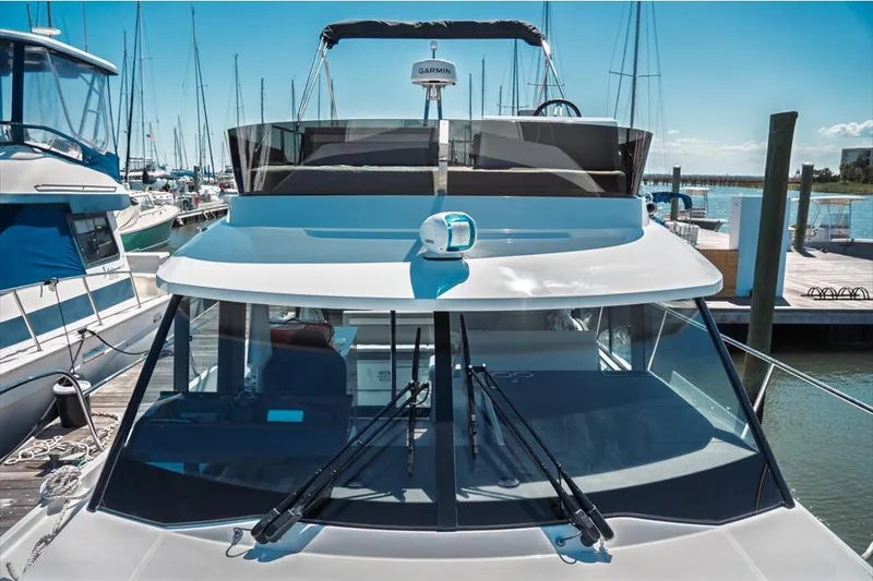Slide: The Image of 2026 Jeanneau NC 1095 Fly Series 2 boat with sleek design and dual outboard engines. - 47