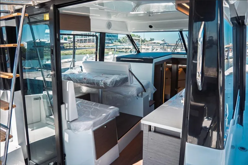 Slide: The Image of 2026 Jeanneau NC 1095 Fly Series 2 boat, side view, sleek design, white hull. - 48