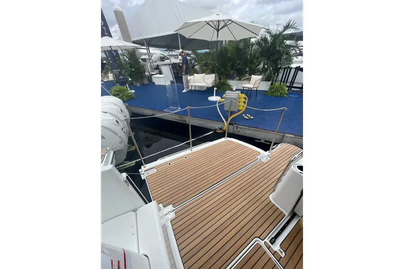 Slide: The Image of 2026 Jeanneau NC 1095 Fly Series 2 yacht docked with elegant outdoor seating area. - 5
