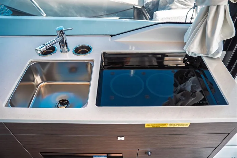 Slide: The Image of 2026 Jeanneau NC 1095 Fly Series 2 yacht deck with seating and ladder. - 52