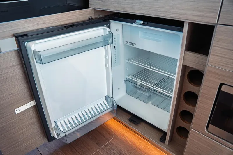 Slide: The Image of 2026 Jeanneau NC 1095 Fly Series 2 yacht docked with elegant outdoor seating area. - 54