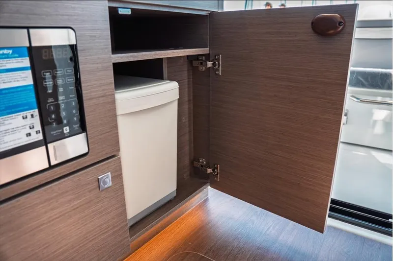 Slide: The Image of Interior of 2026 Jeanneau NC 1095 Fly Series 2 yacht, featuring modern seating and navigation area. - 56