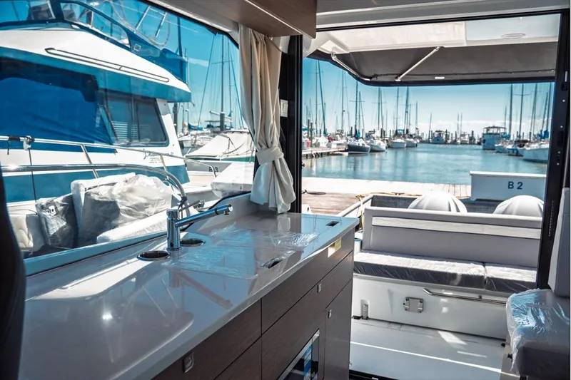 Slide: The Image of Interior of 2026 Jeanneau NC 1095 Fly Series 2 boat, featuring helm and seating area. - 60