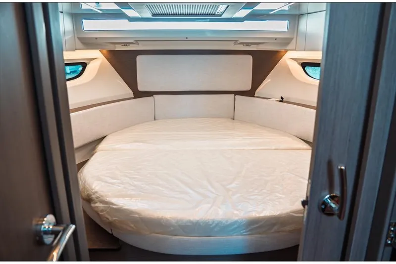 Slide: The Image of 2026 Jeanneau NC 1095 Fly Series 2 cabin interior with modern design and cozy bedding. - 63