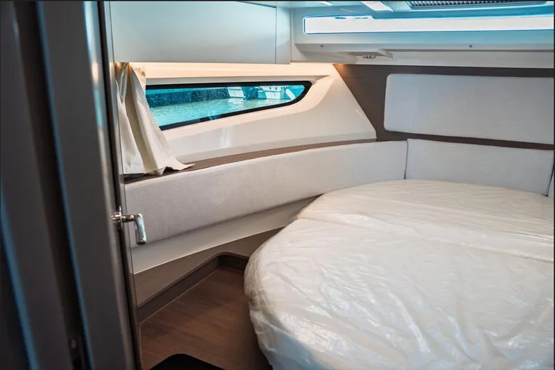Slide: The Image of Interior cabin of 2026 Jeanneau NC 1095 Fly Series 2 with twin beds and magazine. - 64