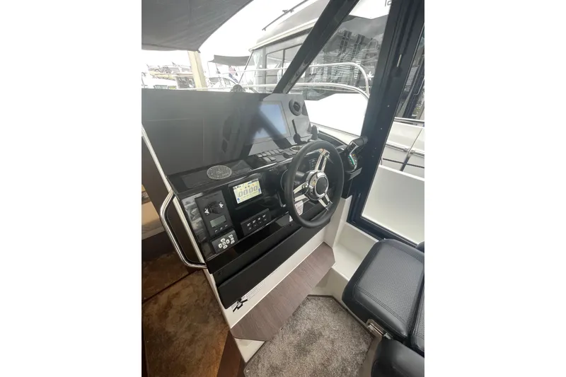 Slide: The Image of 2026 Jeanneau NC 1095 Fly Series 2 helm with modern controls and navigation equipment. - 8