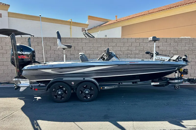 The Image of 2018 Triton 19 TrX Patriot boat with Mercury engine, parked on a trailer. - 0
