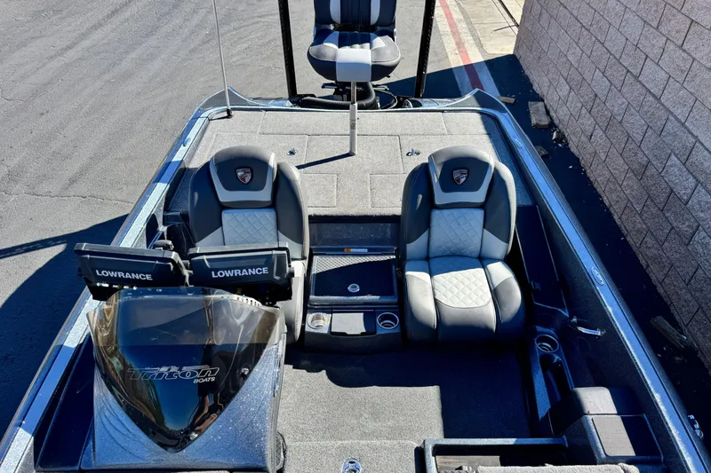 Slide: The Image of 2018 Triton 19 TrX Patriot boat interior with dual Lowrance displays and cushioned seats. - 16