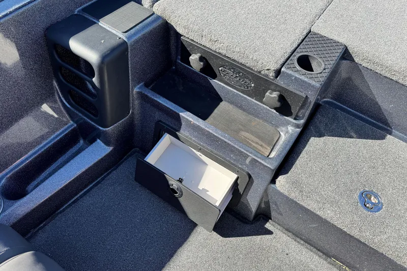 Slide: The Image of 2018 Triton 19 TrX Patriot boat interior with open storage compartment. - 18