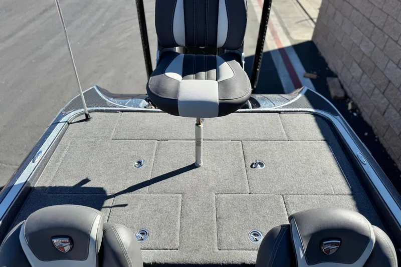 Slide: The Image of 2018 Triton 19 TrX Patriot boat deck with seating and carpeted surface. - 19