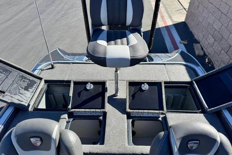 Slide: The Image of 2018 Triton 19 TrX Patriot boat interior with storage compartments and seating. - 20