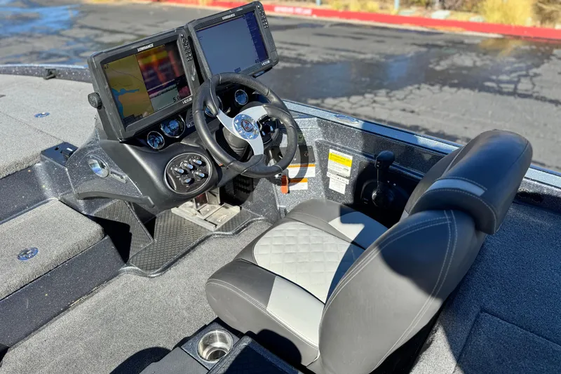Slide: The Image of 2018 Triton 19 TrX Patriot boat cockpit with dual screens and steering wheel. - 22