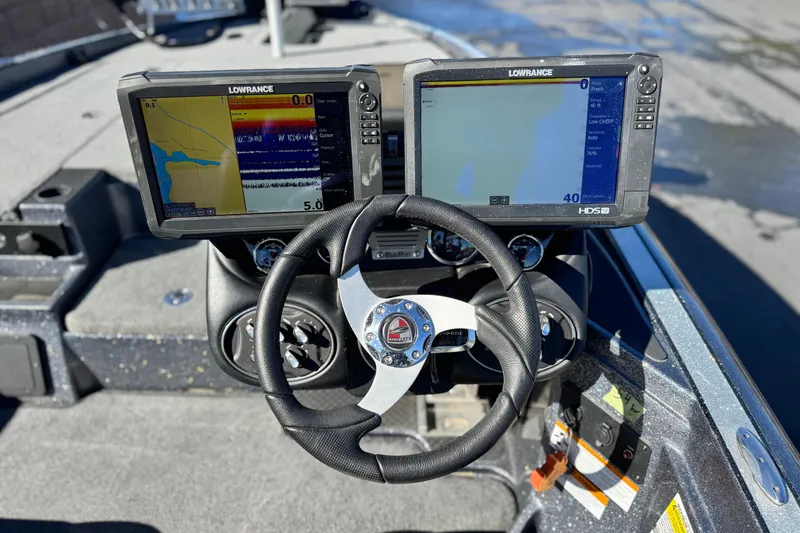 Slide: The Image of 2018 Triton 19 TrX Patriot boat dashboard with dual Lowrance fish finders and steering wheel. - 23