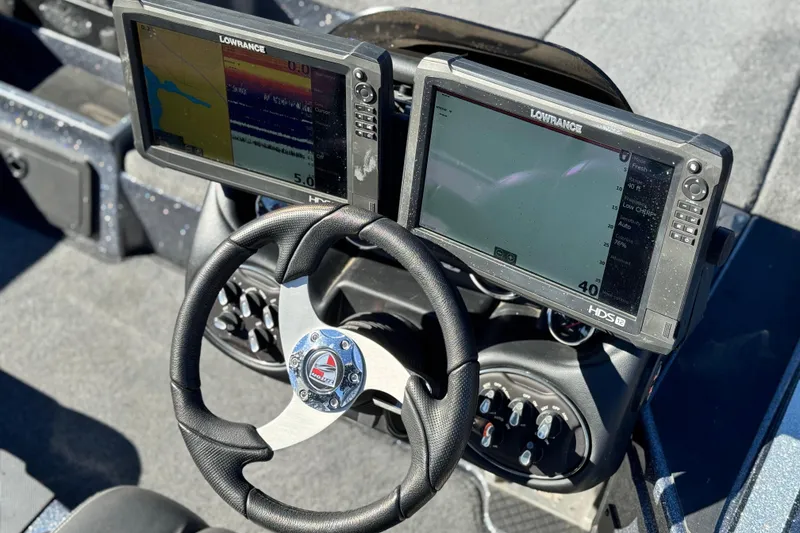 Slide: The Image of 2018 Triton 19 TrX Patriot boat dashboard with dual Lowrance fish finders and steering wheel. - 24