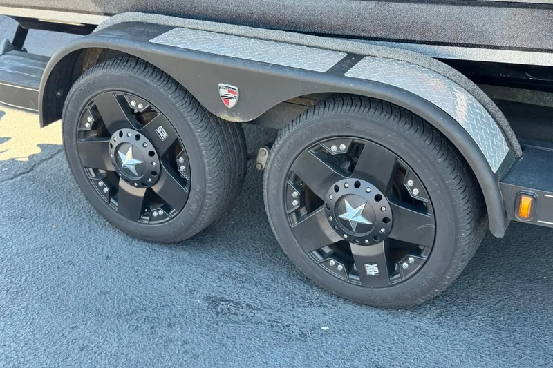 Slide: The Image of 2018 Triton 19 TrX Patriot trailer with black alloy wheels and diamond plate fenders. - 25