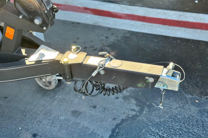 Slide: The Image of Trailer hitch of a 2018 Triton 19 TrX Patriot on pavement. - 26