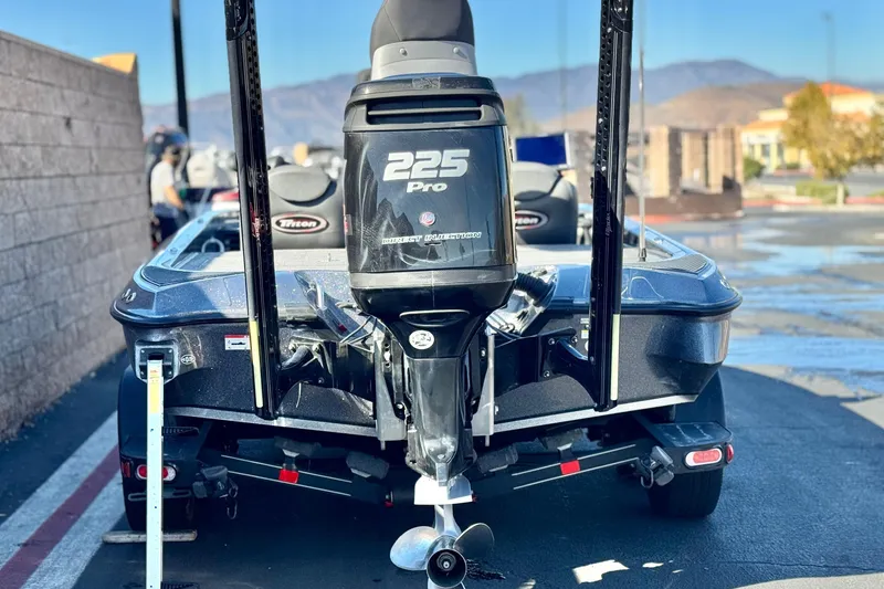 Slide: The Image of 2018 Triton 19 TrX Patriot boat with 225 Pro engine, parked outdoors. - 4