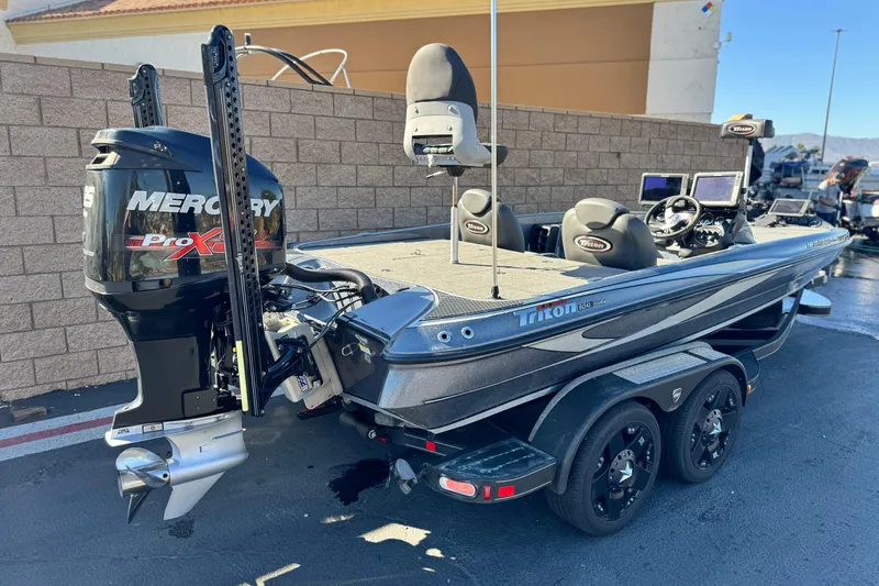 Slide: The Image of 2018 Triton 19 TrX Patriot boat with Mercury Pro XS engine, parked outdoors. - 5